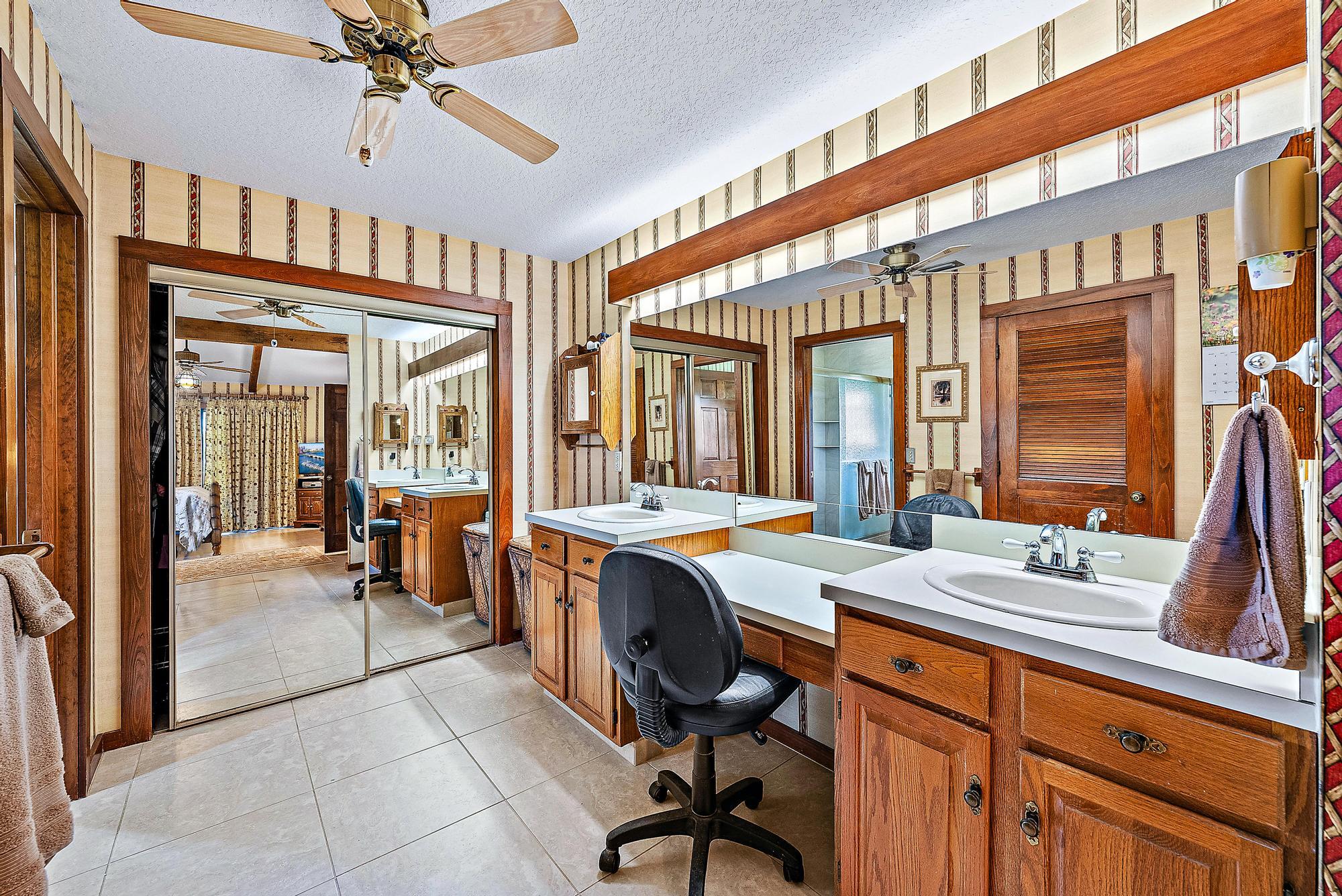 16800 128th Trail North Jupiter, FL 33478 - Photo 18 of 52 a view of a very nice looking dining room with a large window and chandelier