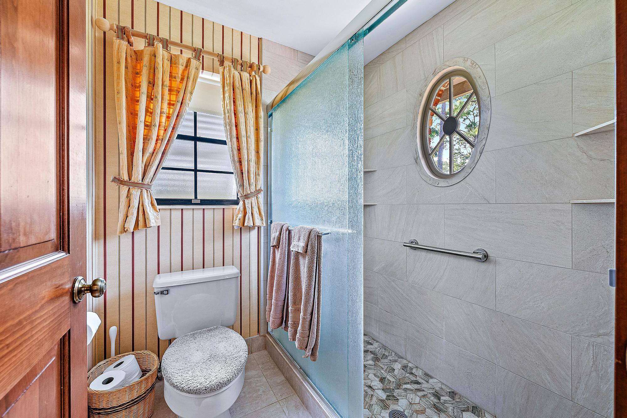 16800 128th Trail North Jupiter, FL 33478 - Photo 19 of 52 a white toilet sitting next to a shower curtain