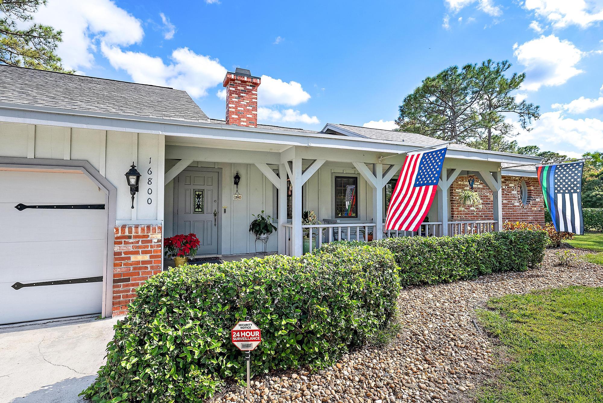 16800 128th Trail North Jupiter, FL 33478 - Photo 26 of 52 a front view of a house with garden