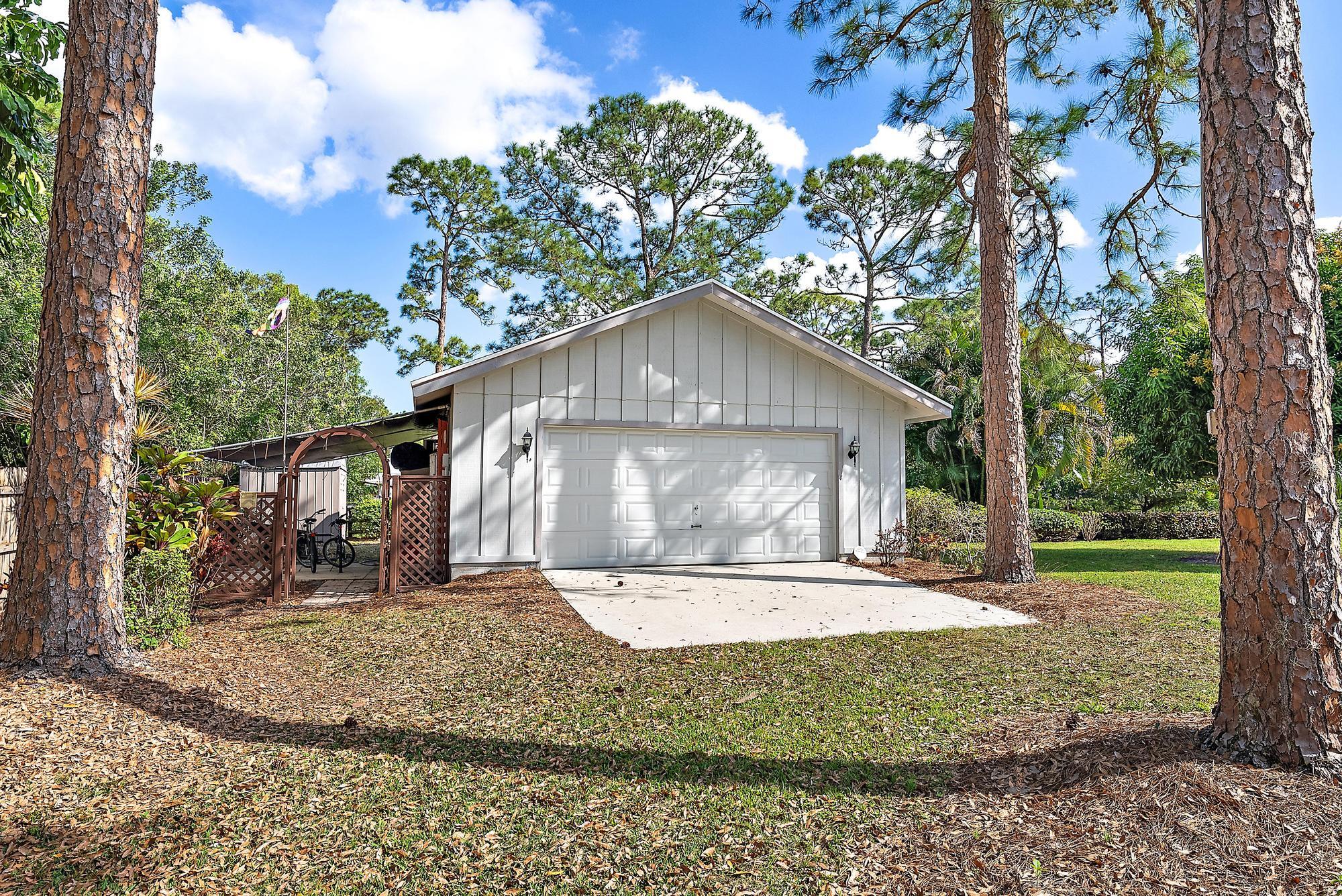 16800 128th Trail North Jupiter, FL 33478 - Photo 29 of 52 a front view of a house with a yard