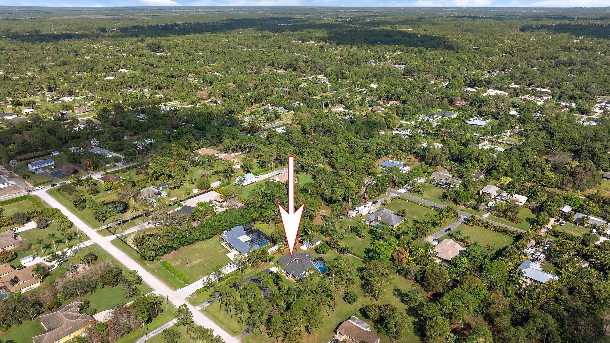16800 128th Trail North Jupiter, FL 33478 - Photo 42 of 52 a view of a lake with a field
