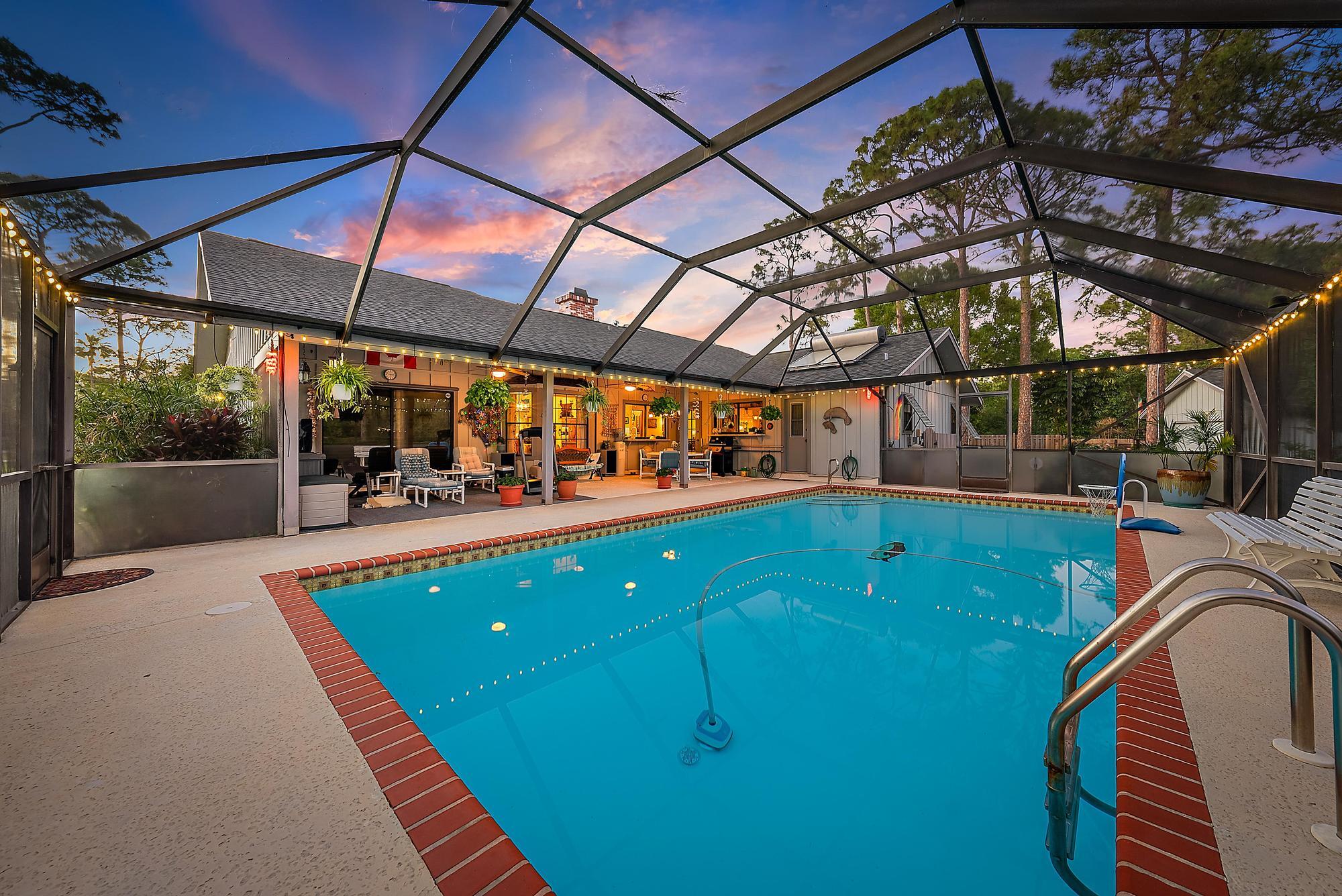 16800 128th Trail North Jupiter, FL 33478 - Photo 46 of 52 a view of a swimming pool with a patio