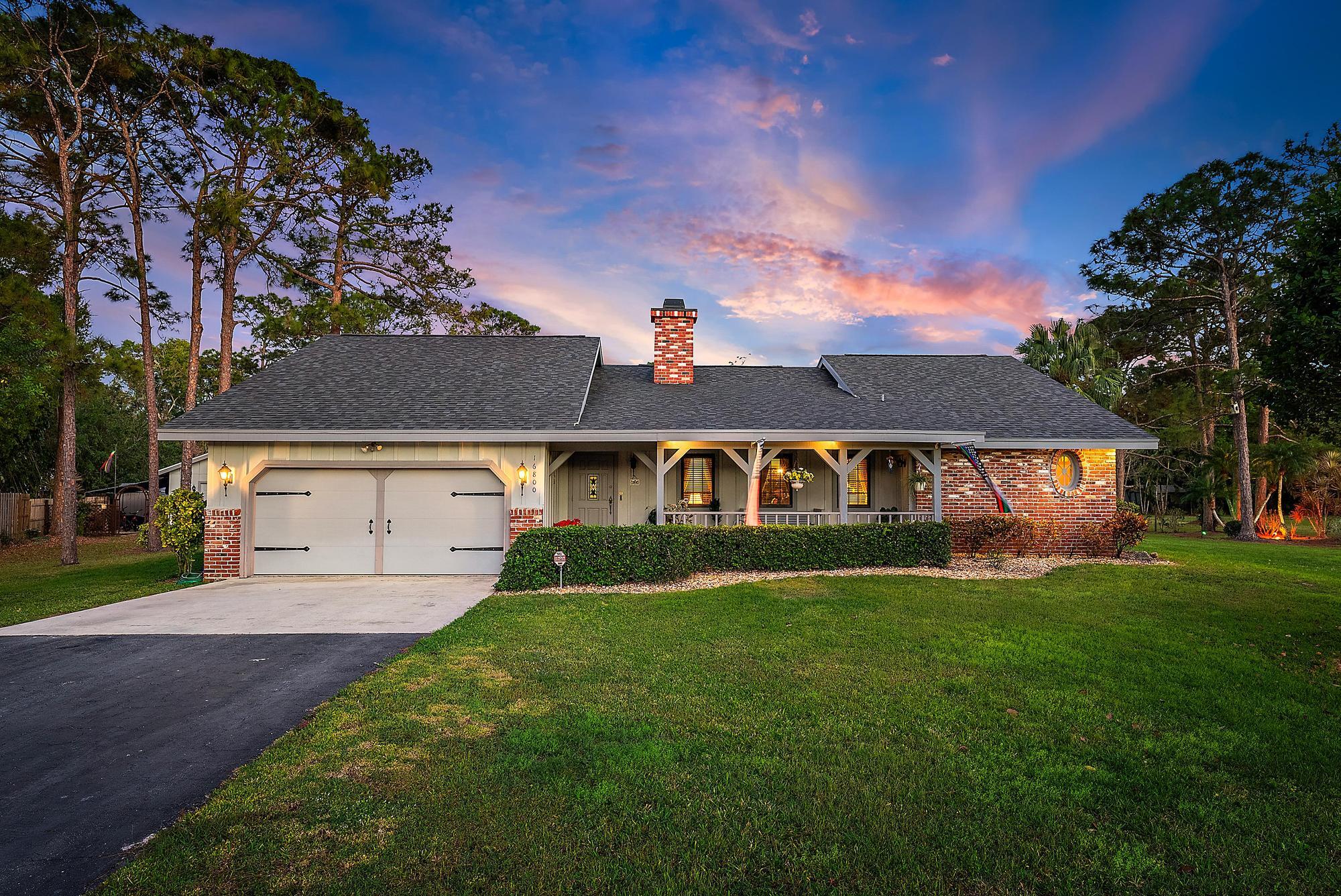 16800 128th Trail North Jupiter, FL 33478 - Photo 49 of 52 front view of house with a yard
