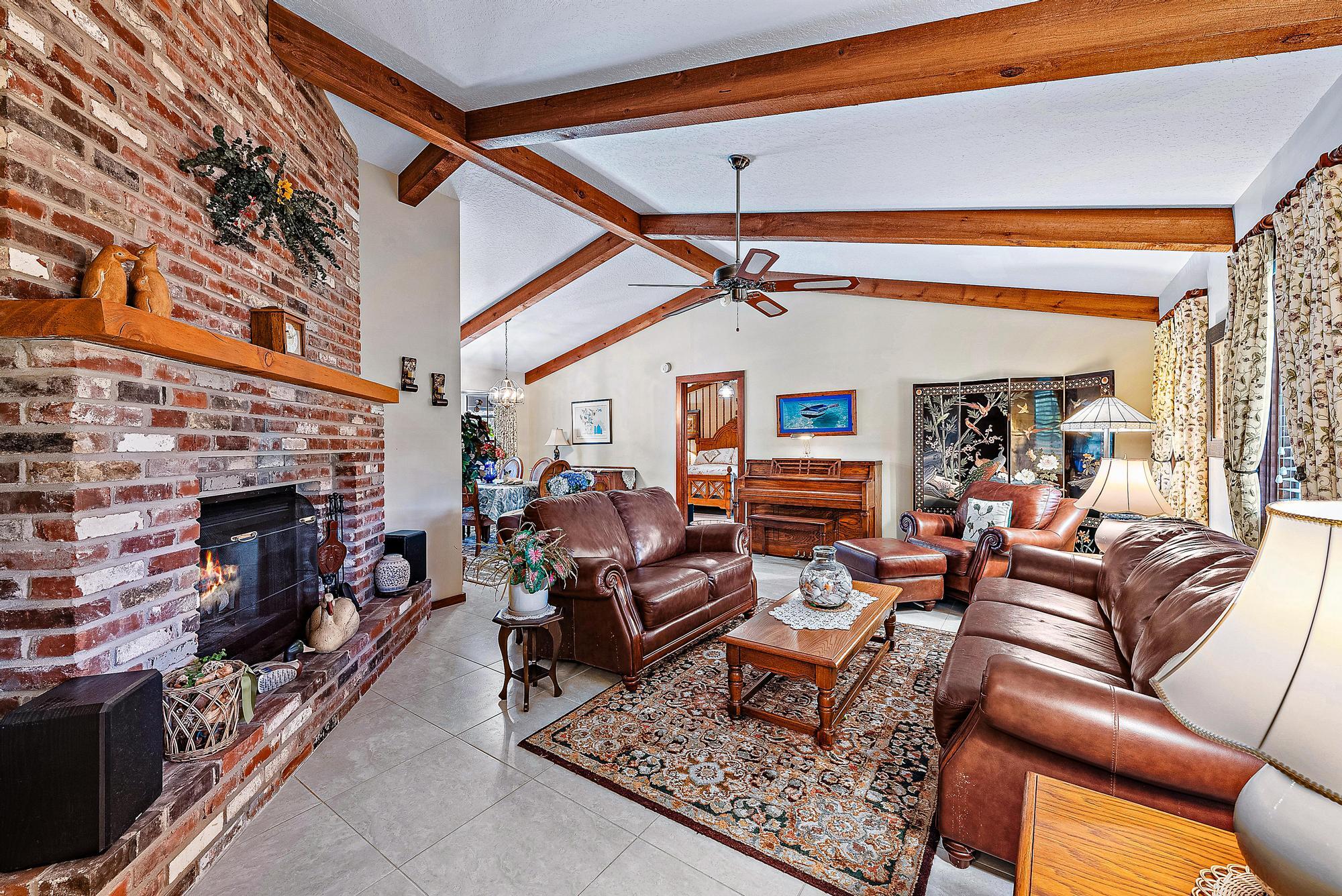 16800 128th Trail North Jupiter, FL 33478 - Photo 5 of 52 a living room with furniture and a fireplace