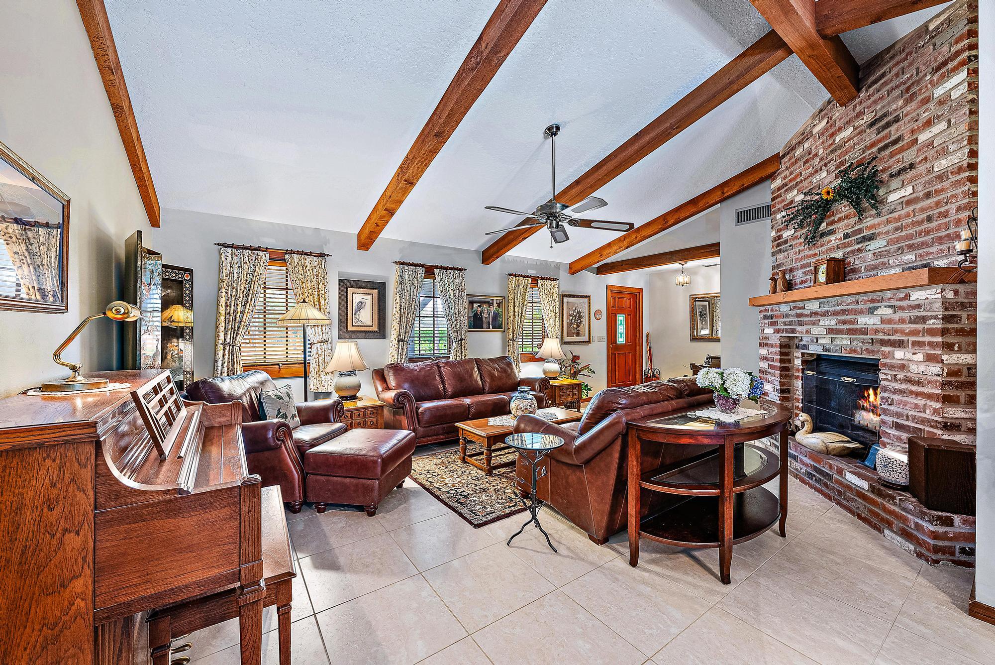 16800 128th Trail North Jupiter, FL 33478 - Photo 6 of 52 a living room with fireplace furniture and a fireplace