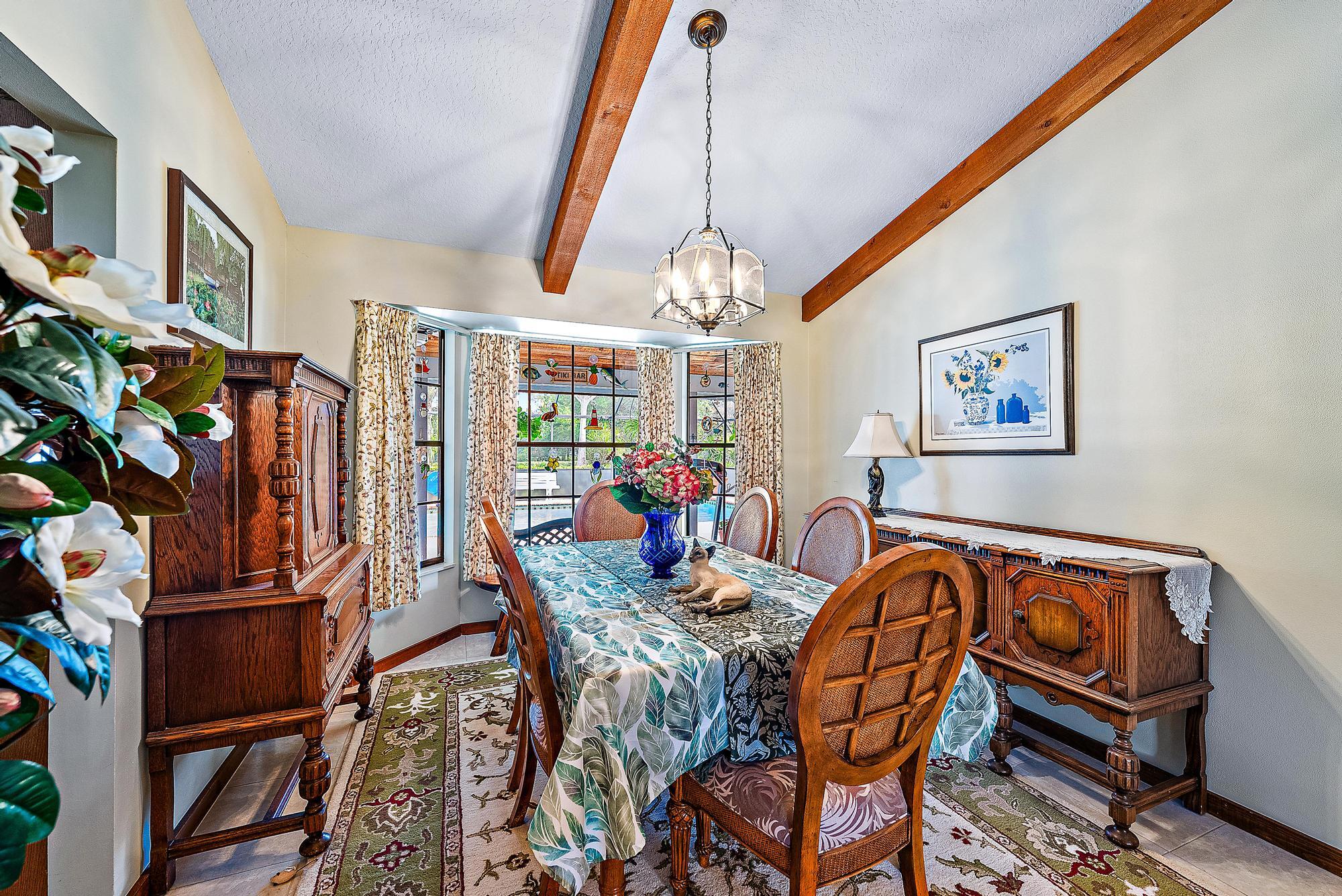 16800 128th Trail North Jupiter, FL 33478 - Photo 8 of 52 a view of a dining room with furniture window and wooden floor