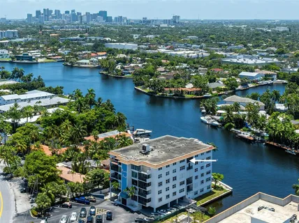 an aerial view of a houses with a lake view