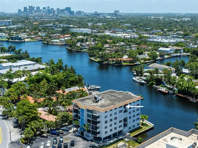 an aerial view of a houses with a lake view