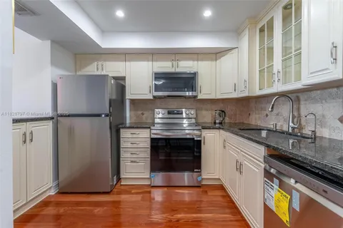 a kitchen with a refrigerator and a sink