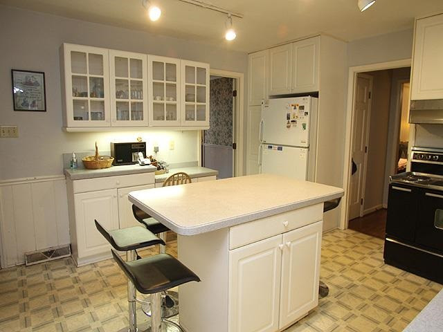 1104 Country Ridge Drive Raleigh, NC 27609 - Photo 8 of 24 Kitchen Features Island and Corian Counters Kitchen