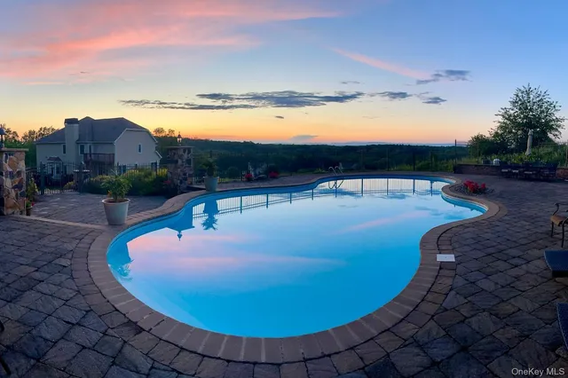 a view of a swimming pool with a table and chairs