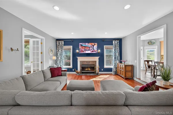 a living room with furniture large window and fireplace
