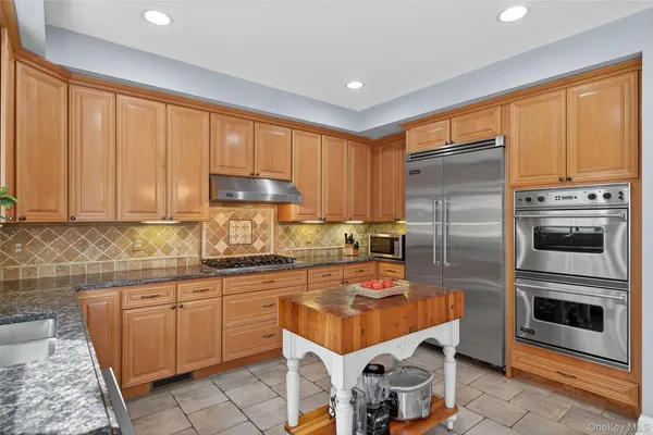 a kitchen with stainless steel appliances a stove a sink and a refrigerator