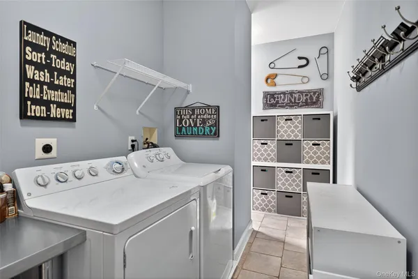 a utility room with multiple dryer and washer