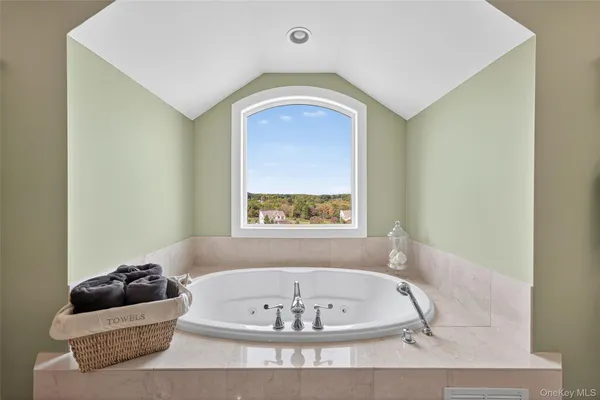 a bath tub sitting in a bathroom next to a window