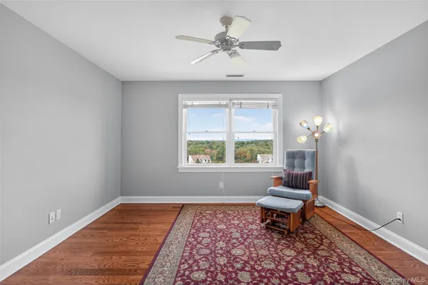 a living room with a rug and a window