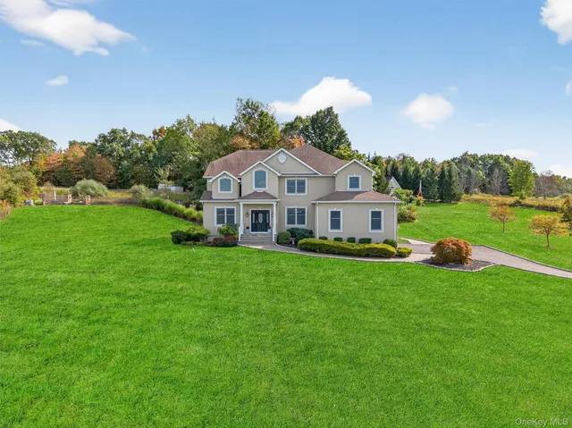 a front view of a house with a garden and yard