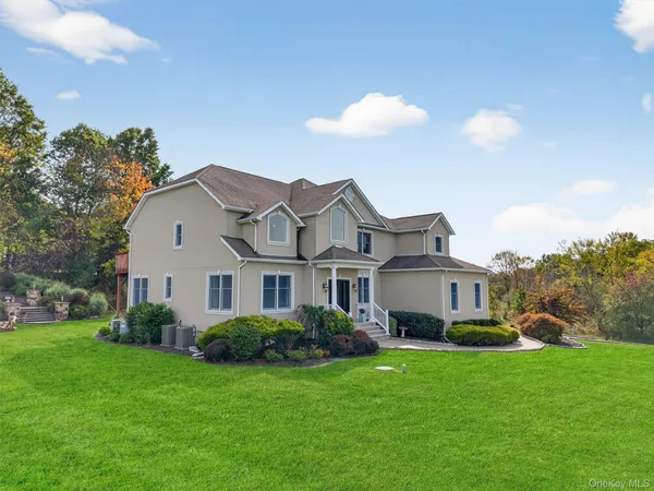 a view of a house with a backyard