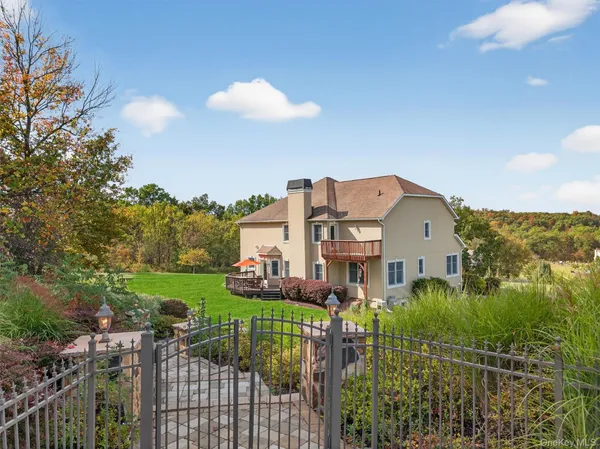 a view of a house with a big yard and a garden