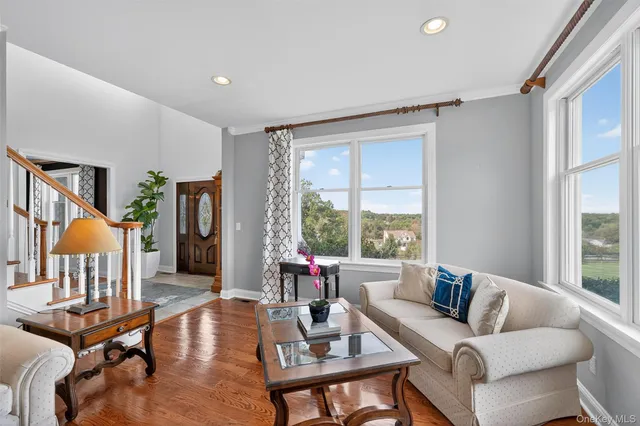 a living room with furniture large window and fireplace