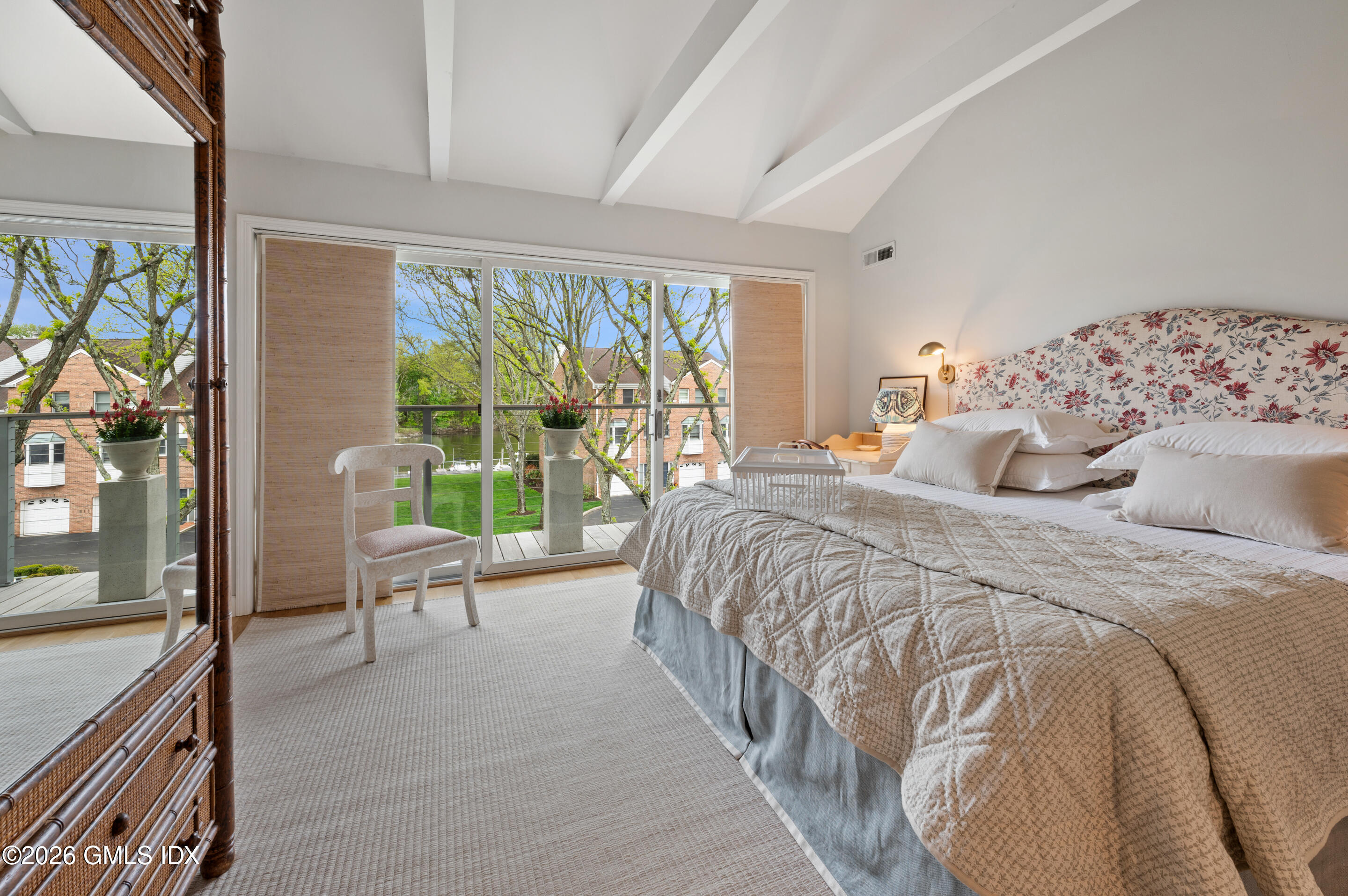 115 River Road, Unit 3 Cos Cob, CT 06807 - Photo 13 of 40 a bedroom with a large bed and a balcony