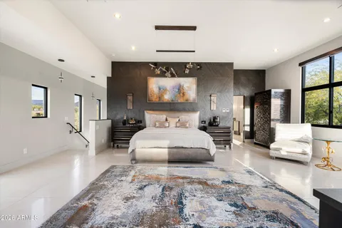 a bedroom with a large bed and a large window