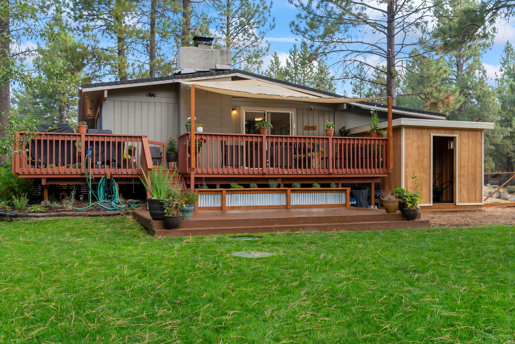 16879 Elsinore Road Bend, OR 97707 - Photo 41 of 48 a view of a house with a yard and a deck