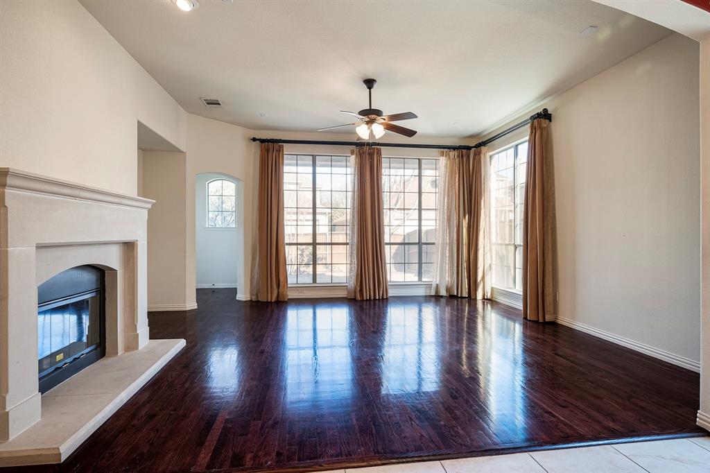 1138 Amy Drive Allen, TX 75013 - Photo 13 of 26 a view of an empty room with wooden floor fireplace and a window