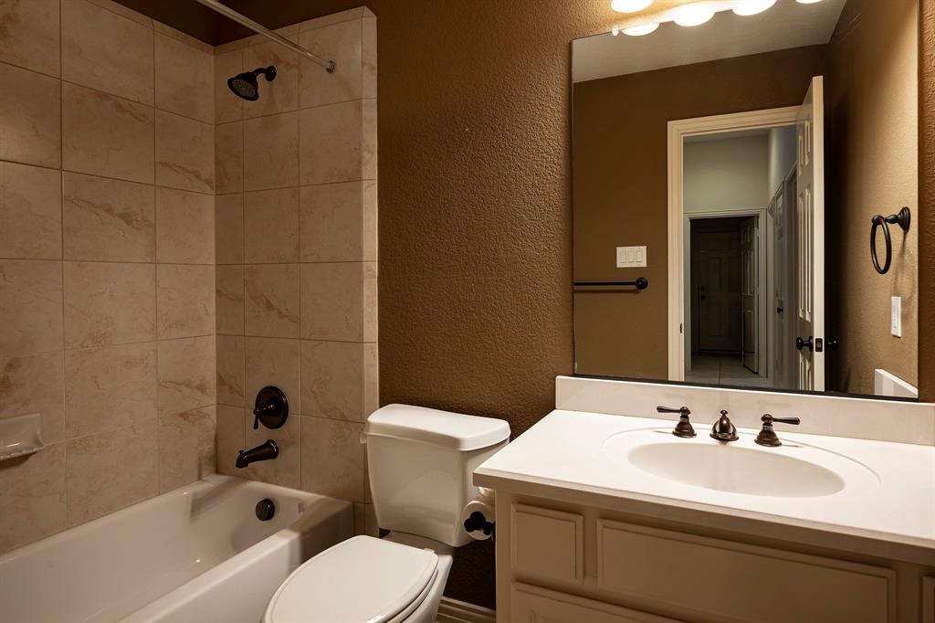 1138 Amy Drive Allen, TX 75013 - Photo 21 of 26 a bathroom with a sink a toilet and shower