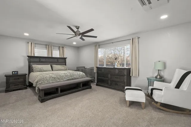 a spacious bedroom with a bed and a couch