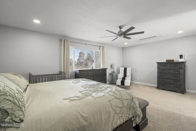 a bedroom with a bed and a ceiling fan