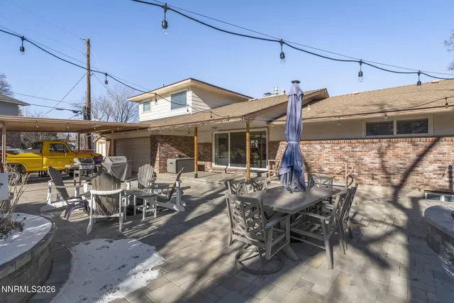 a view of a patio with table and chairs potted plants
