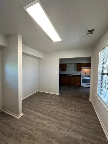 an empty room with closet and windows