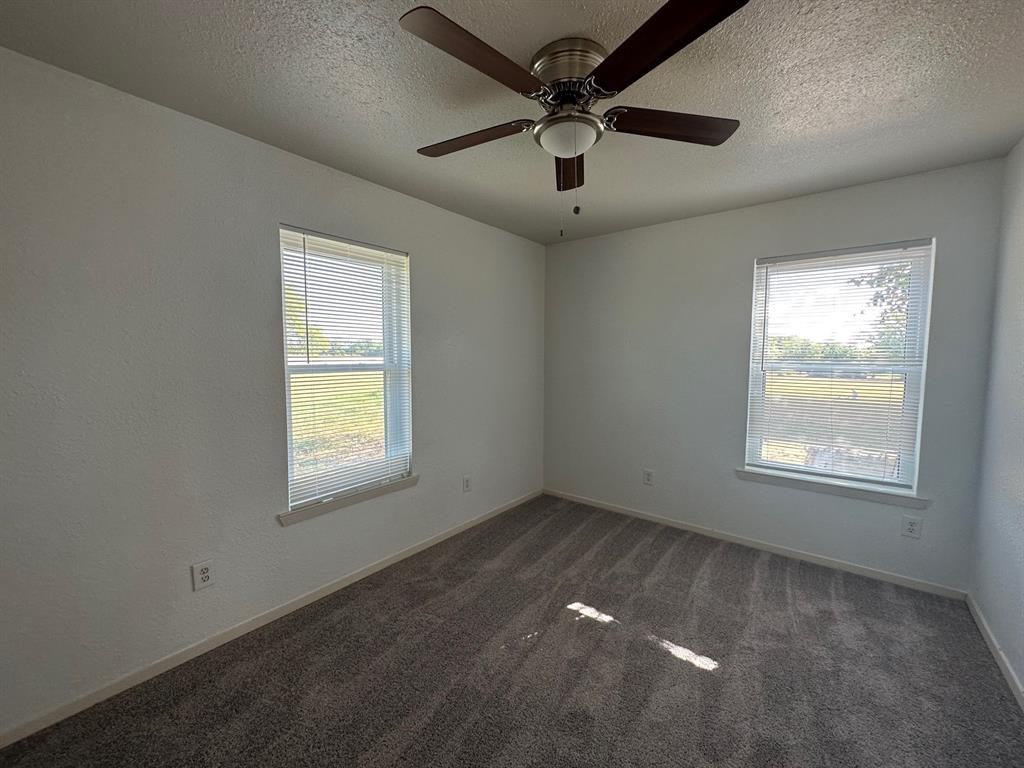 2520 County Road 406 McKinney, TX 75071 - Photo 8 of 19 an empty room with a window and a fan