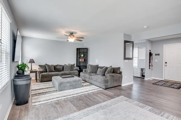 a living room with furniture and a chandelier