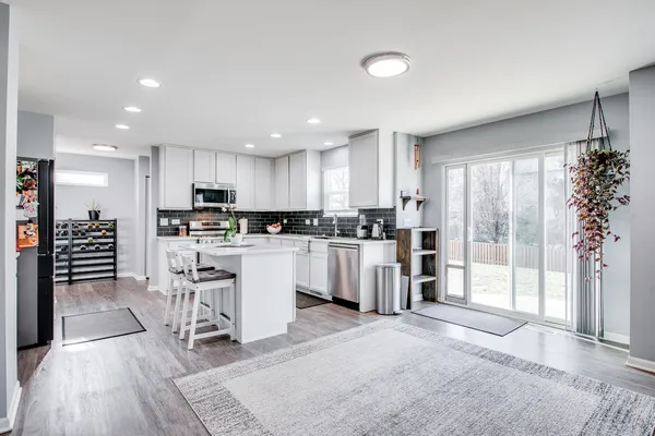 a kitchen with sink stove and cabinets