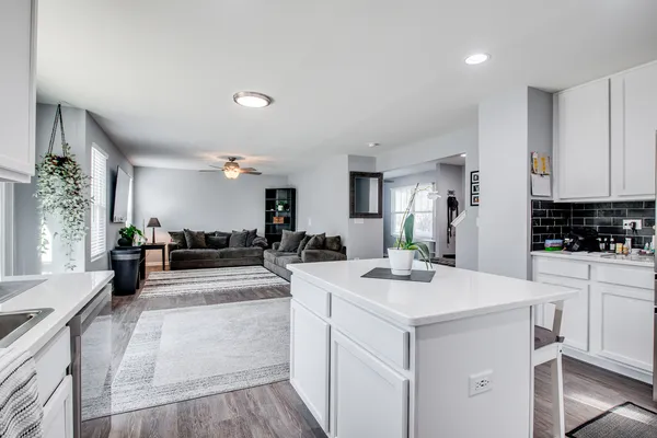 a kitchen with white cabinets and appliances