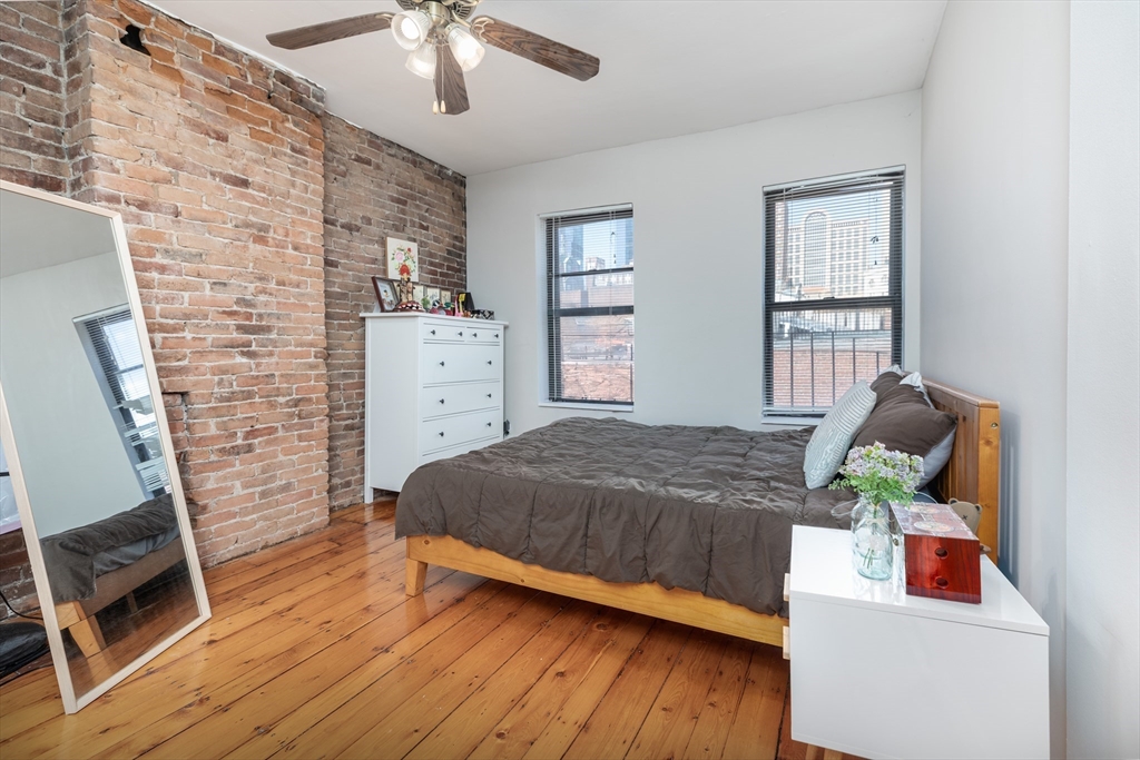 75 Chandler Street, Unit 7 Boston, MA 02116 - Photo 5 of 11 a bedroom with a bed and wooden floor