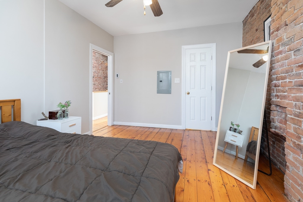 75 Chandler Street, Unit 7 Boston, MA 02116 - Photo 6 of 11 a bedroom with a bed and a chandelier