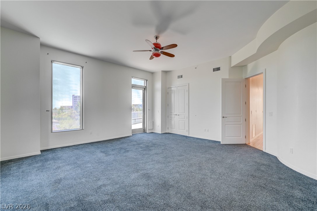 360 East Desert Inn Road, Unit 402 Las Vegas, NV 89109 - Photo 19 of 40 A spacious chamber with lofty ceilings and plush carpeting.