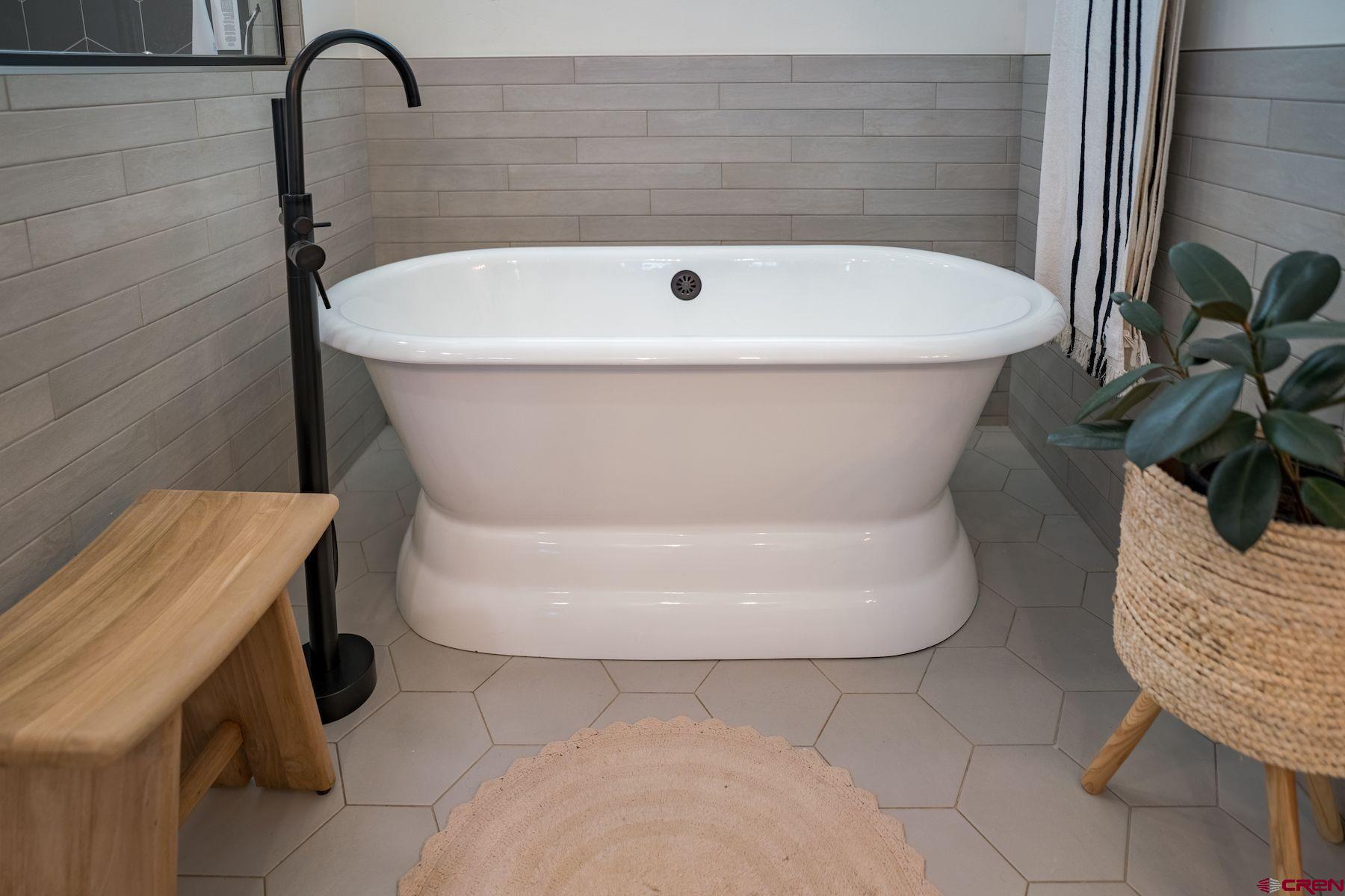 67 Range Road Durango, CO 81303 - Photo 17 of 34 a white bath tub sitting in a bathroom