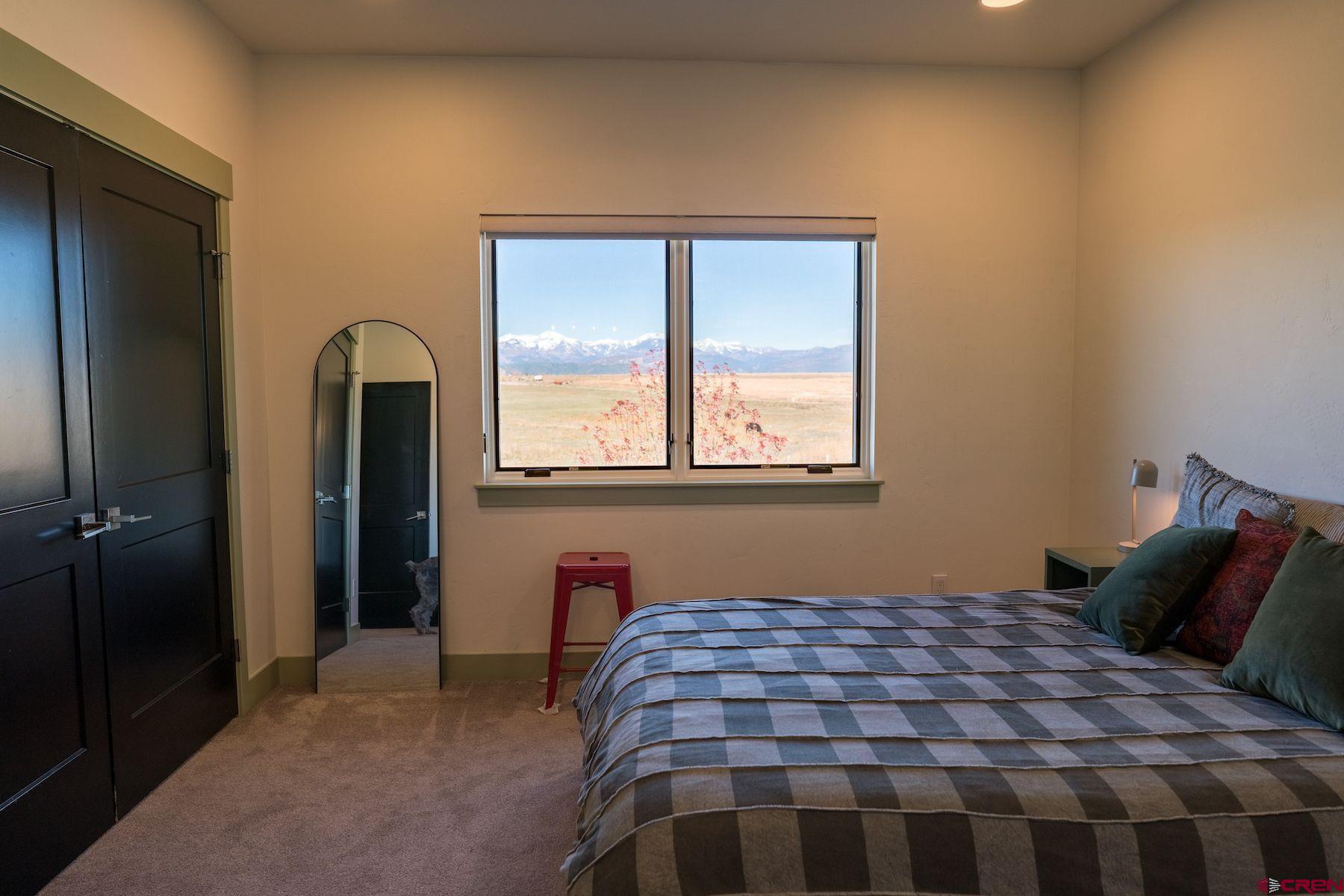 67 Range Road Durango, CO 81303 - Photo 24 of 34 a bedroom with a bed and window