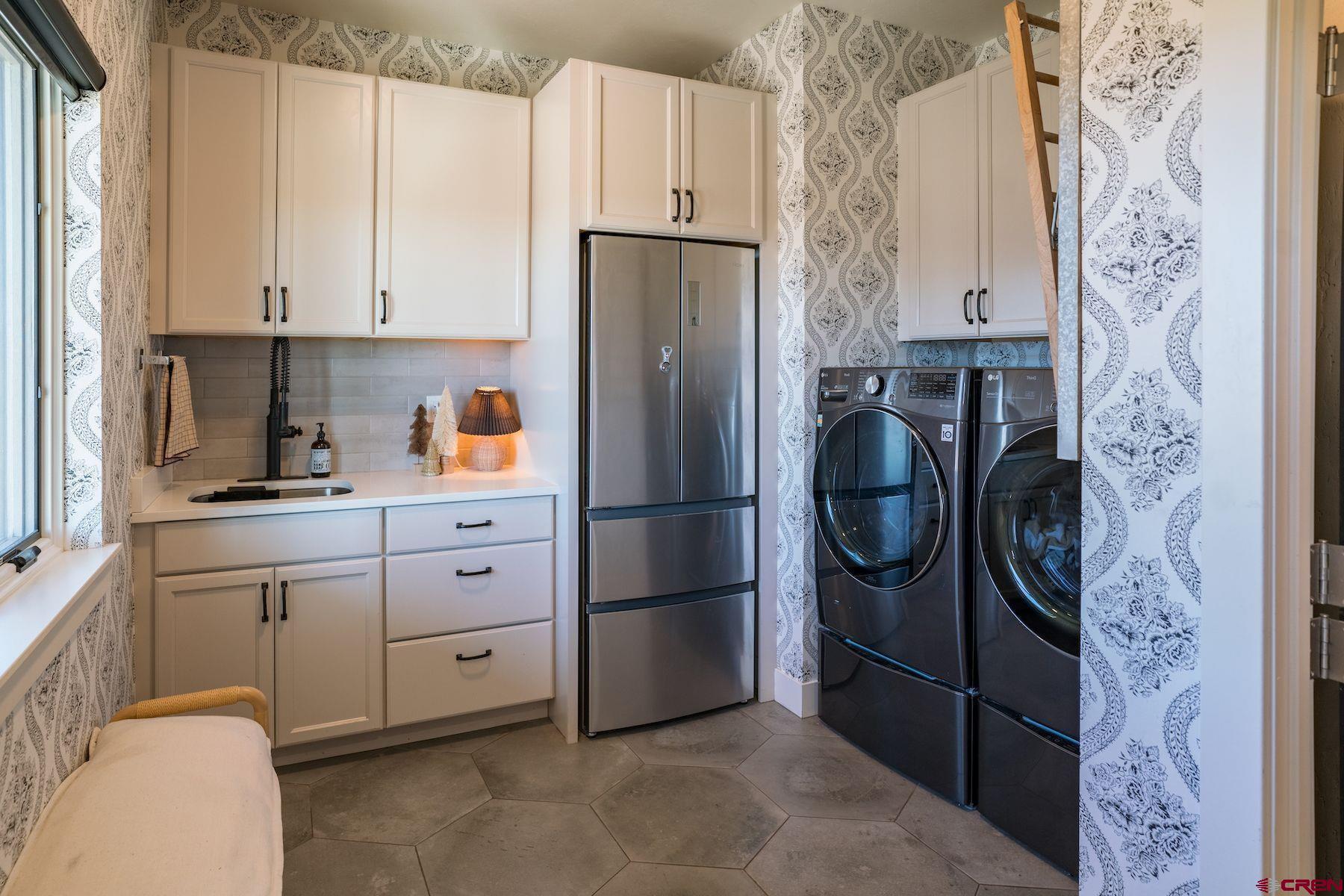 67 Range Road Durango, CO 81303 - Photo 26 of 34 a kitchen with a refrigerator and cabinets