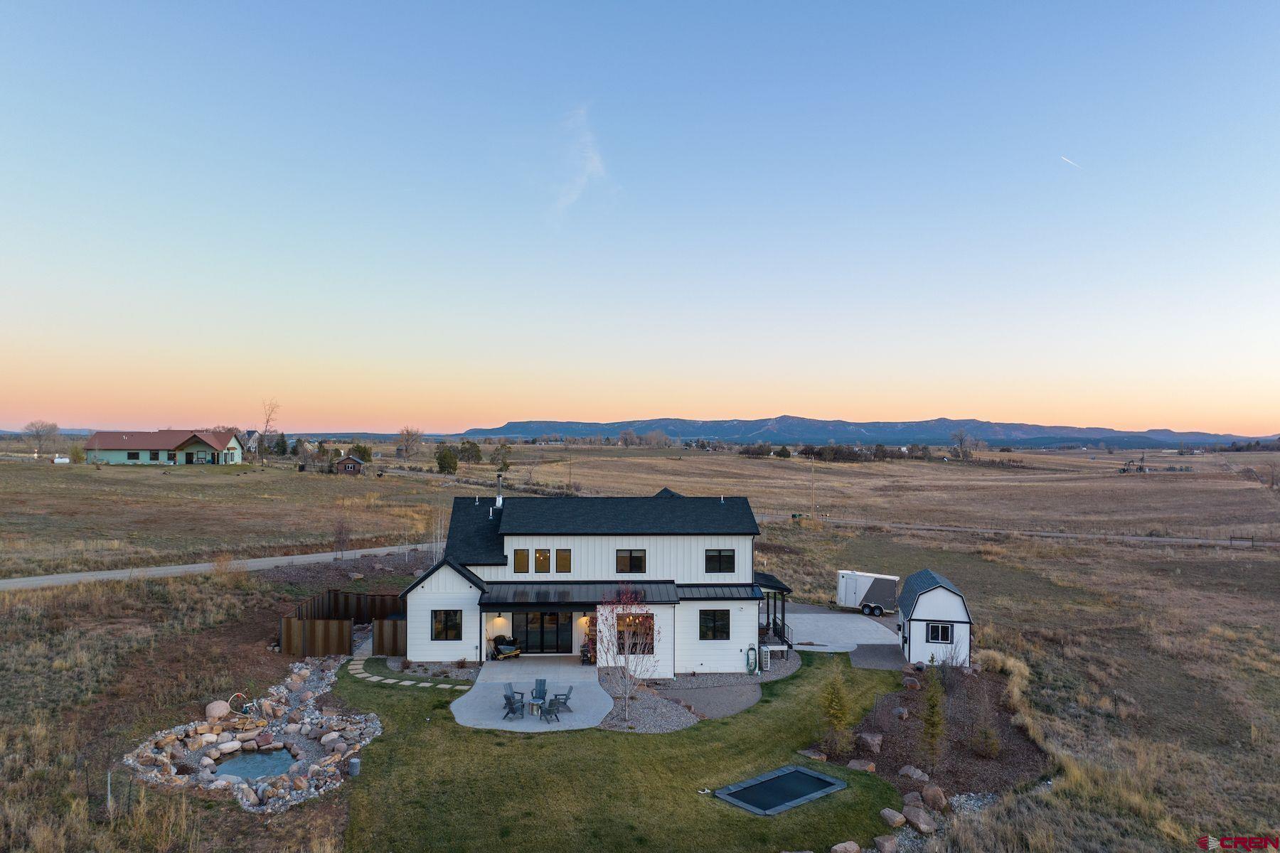 67 Range Road Durango, CO 81303 - Photo 32 of 34 a view of a big house with a big yard and large tree