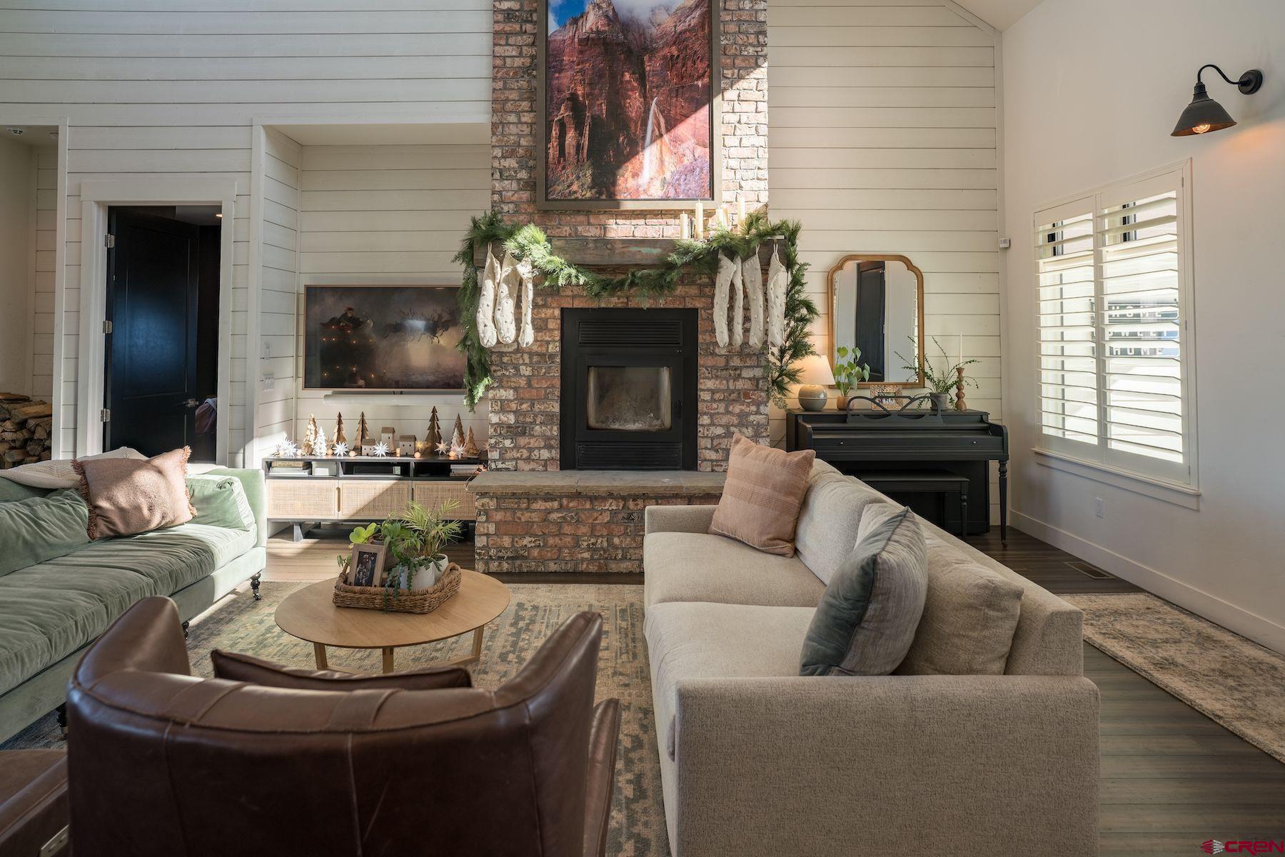 67 Range Road Durango, CO 81303 - Photo 4 of 34 a living room with furniture a fireplace and a flat screen tv