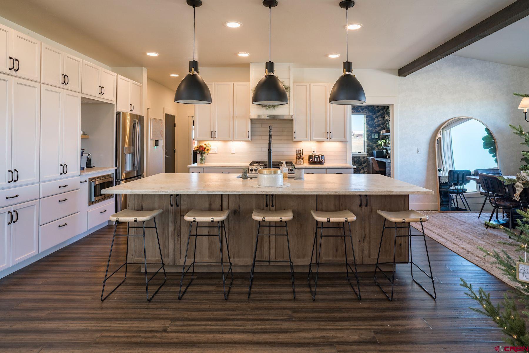 67 Range Road Durango, CO 81303 - Photo 9 of 34 a kitchen with stainless steel appliances granite countertop a stove a sink refrigerator and cabinets
