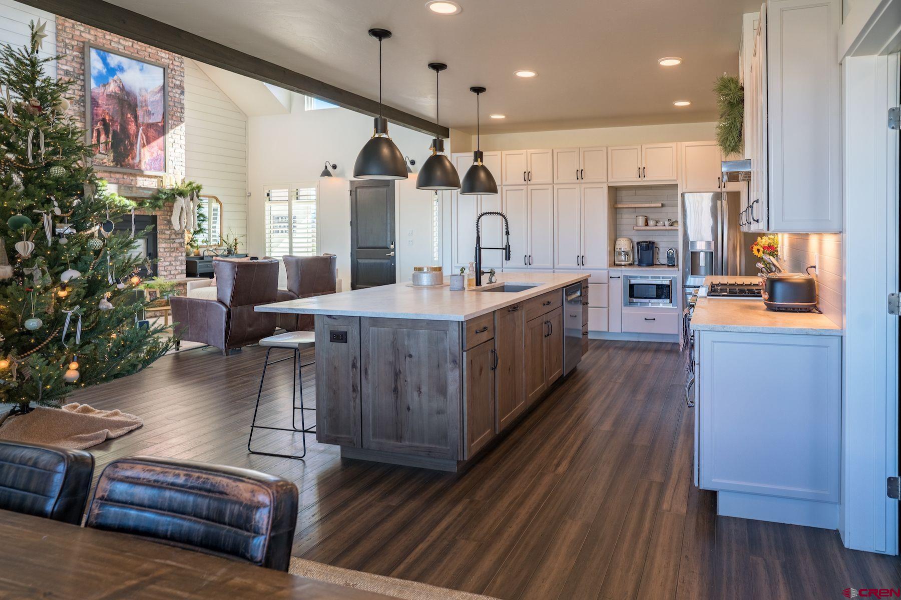 67 Range Road Durango, CO 81303 - Photo 10 of 34 a large living room with stainless steel appliances kitchen island granite countertop furniture and a wooden floor