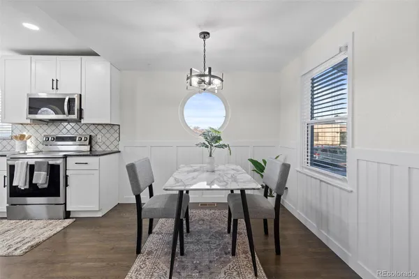a view of a dining room with furniture and wooden floor