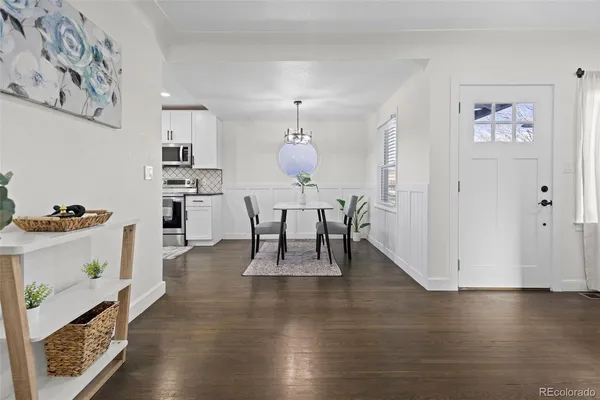 a dining room with furniture and wooden floor
