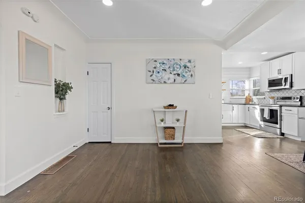 a view of kitchen with wooden floor and electronic appliances